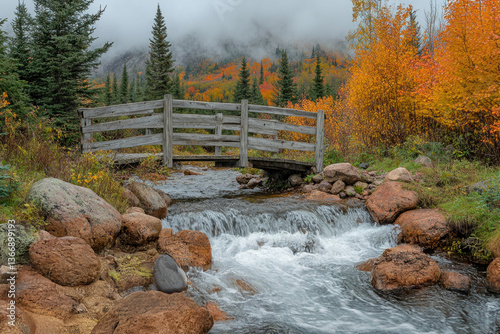 Scenic Autumn Landscape with Bridge Over Stream in Misty Forest Setting