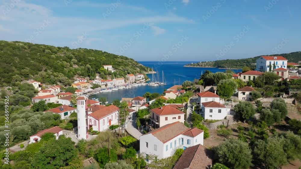 Aerial establishing overview of Kioni village, Ithaca Island, Greece, with red-roofed houses and a turquoise bay at midday Aerial establishing overview of Kioni village, Ithaca Island, Greece, with red-roofed houses and a turquoise bay at midday