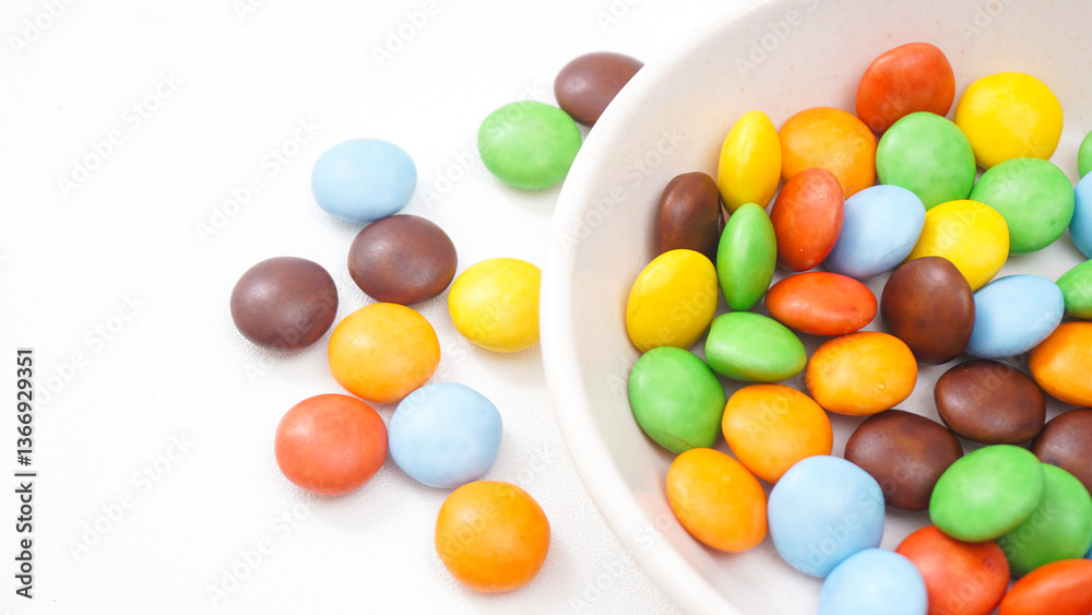 Sugar coated chocolate candies with a vibrant and crunchy texture isolated on white background