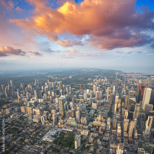 Stunning helicopter view of Toronto skyline glowing at sunset over Lake Ontario