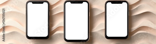 Three smartphones resting on a textured background with soft color