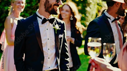 Elegant ladies and gentlemen holding glasses of champagne at a racing event, spring garden party. Old Money style, warm sunlight, luxury lifestyle atmosphere