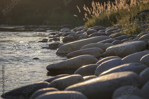 large smooth river stones scattered along the gently flowing water's edge