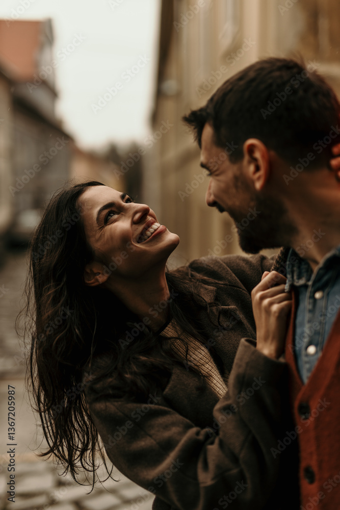 Happy couple laughing and playing on a date in Prague Happy couple laughing and playing on a date in Prague
