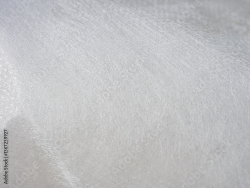 Lightweight, flexible nonwoven fabric. Ideal for various applications. Material properties & textile construction visible.