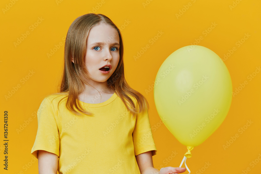Surprised girl with yellow balloon and yellow background, wearing a bright t shirt, expressing wonder in a colorful, cheerful setting Surprised girl with yellow balloon and yellow background, wearing a bright t shirt, expressing wonder in a colorful, cheerful setting