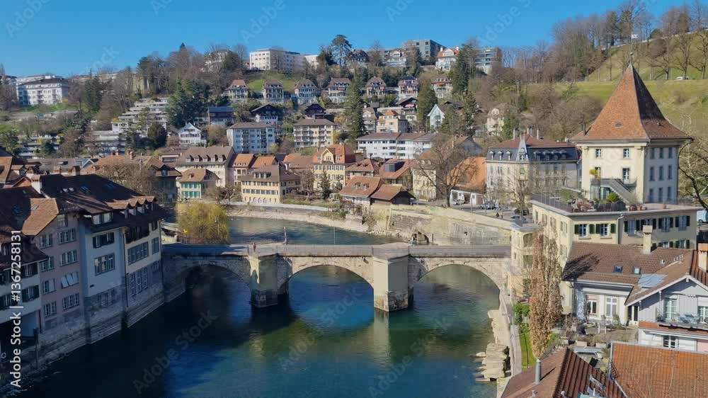 Shot of the historical stone bridge Untertorbrücke in the unesco protected old town of Bern on a beautiful sunny spring day, showing also the green waters of Aare river Shot of the historical stone bridge Untertorbrücke in the unesco protected old town of Bern on a beautiful sunny spring day, showing also the green waters of Aare river