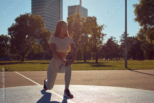 Obraz na płótnie Young woman stretching after exercise and jogging in urban park w salonie