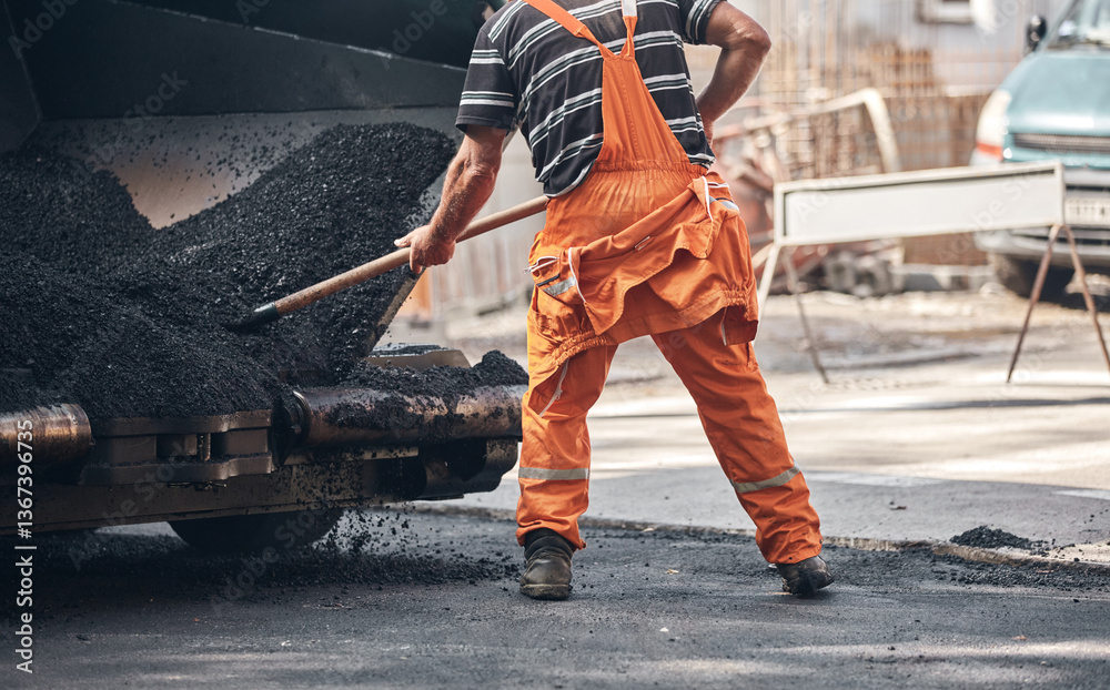 Construction workers working on a new asphalt layer on a public street.