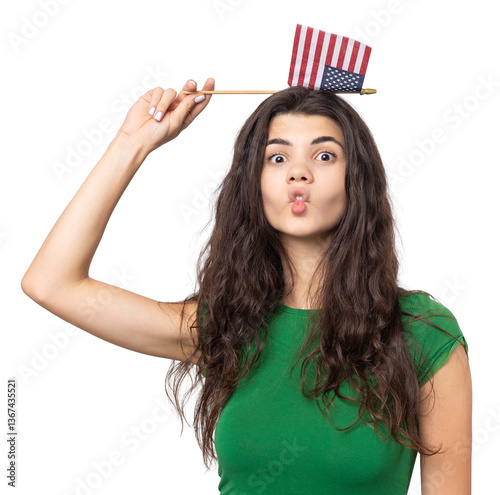 A young happy girl with a smile on her face holds an American flag in her hands. Symbol of patriotism and freedom.