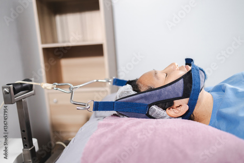 traction neck therapy, physical therapy, person undergoing physical therapy for neck traction, using specialized equipment to relieve discomfort and promote healing