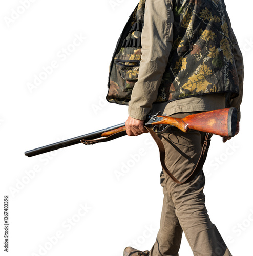 Mature man hunter with gun while walking on field.