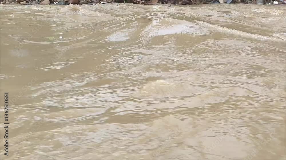The rapid flow of river water is cloudy and dirty.
Nature concept. Water pollution.
