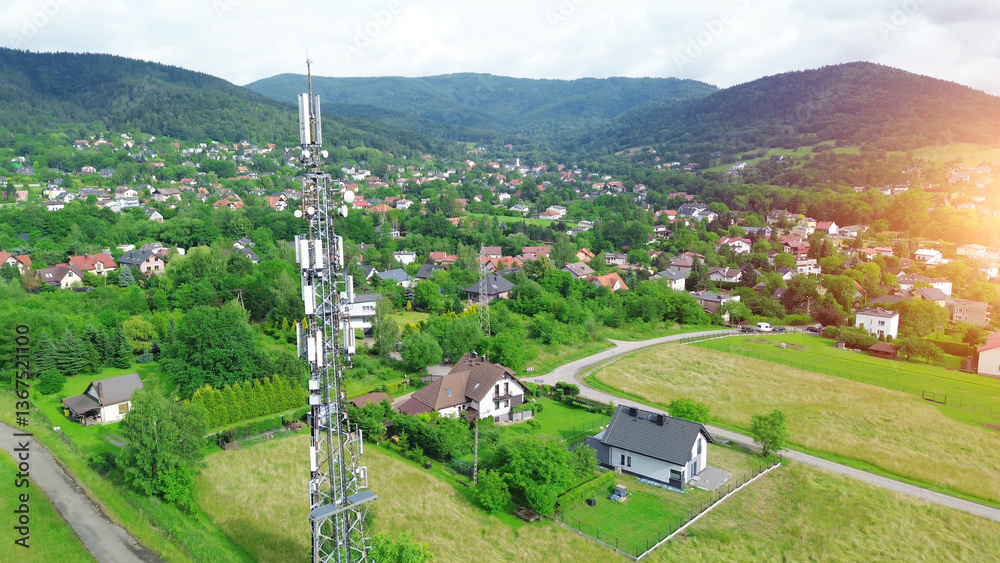 5G Telecommunications tower above rural town and highway