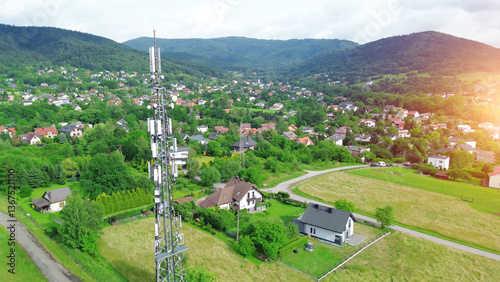 Obraz na płótnie 5G Telecommunications tower above rural town and highway w salonie