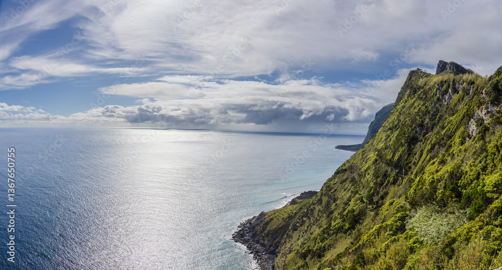 Steep cliffs rise vertically from the Atlantic Ocean on the southern coast of the island of Flores Steep cliffs rise vertically from the Atlantic Ocean on the southern coast of the island of Flores