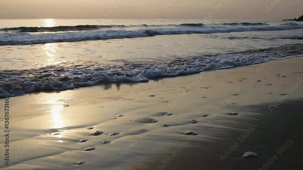 Serenity of ocean waves gently receding on tranquil beach at sunset