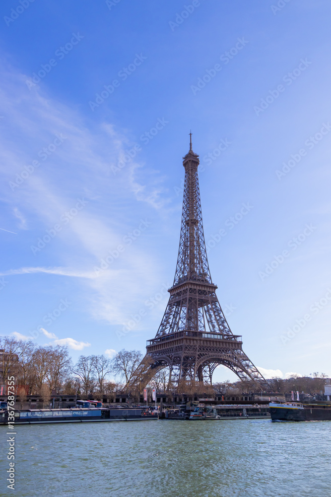 Fototapeta premium Paris, France - February 23, 2025: Eiffel Tower on the Seine River in Paris, France, early spring