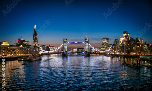 Obraz na płótnie Panoramic night, low angle view of the illuminated Tower Bridge and city skyline of London, England w salonie