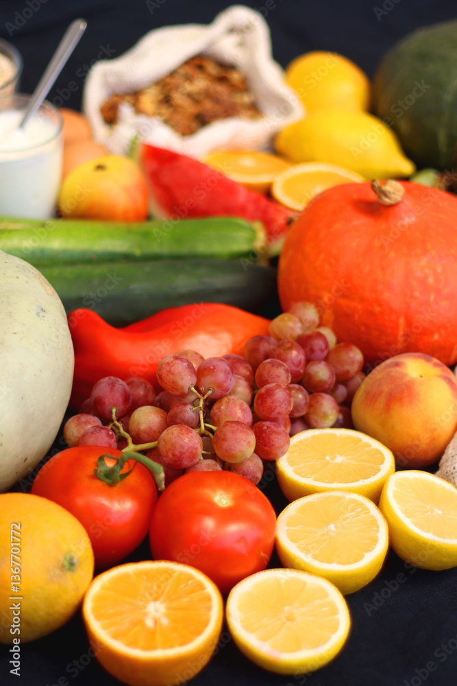 Various healthy fruits, vegetables and cereals on dark background. Selective focus.
