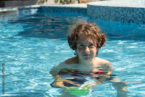 Obraz na płótnie Teenager swims in swimming pool in summer. Outdoors. Summer vacation w salonie