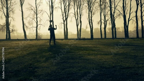 Teenager head juggling a ball in morning sun