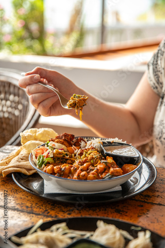 Woman eating a Buddha Bowl, Varkala Beach, Kerala, India