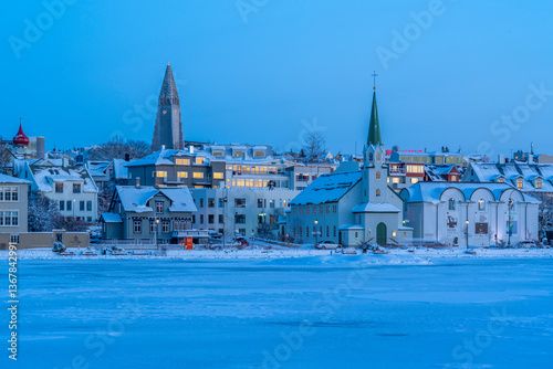 View of the Hallgrimskirkja Church and city skyline of Reykjavik from Tjornin lake at sunset in winter, Reykjavik