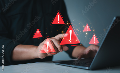 Businessman using laptop with spam virus with warning to alert internet security and data breach or hacker or spyware.