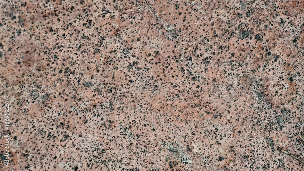 Natural granite surface texture, speckled for backgrounds or design projects, close-up. Natural granite surface texture, speckled for backgrounds or design projects, close-up.