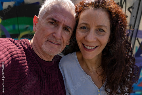 beautiful smiling middle aged couple taking a funny selfie outdoors