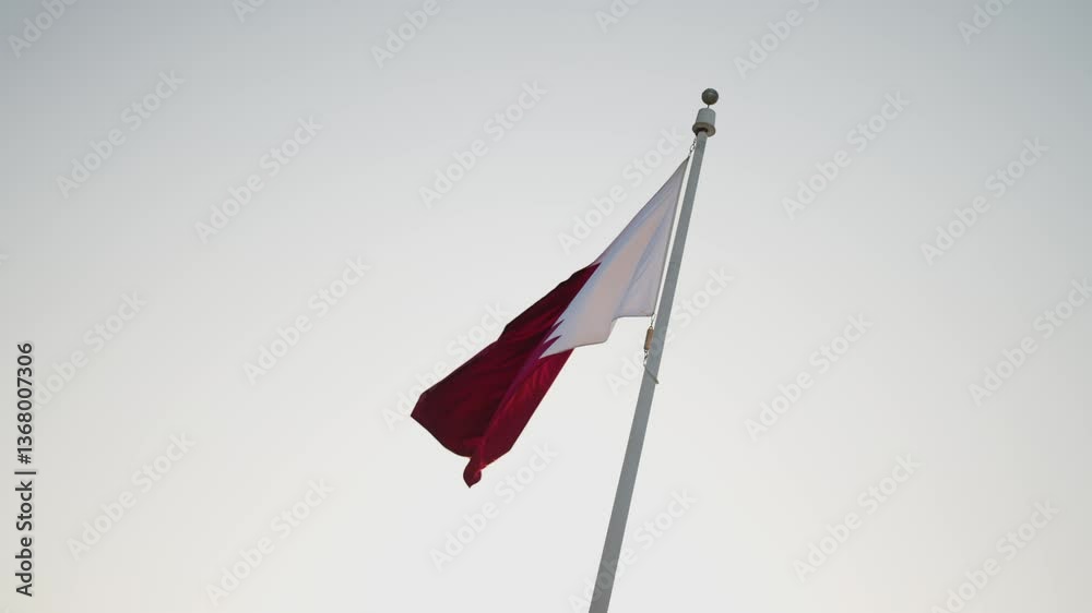 Detail of qatar flag in slowmotion in sunset