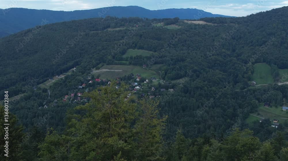 Scenic view of a small village surrounded by dense forest in the Beskid Slaski mountains of southern Poland Scenic view of a small village surrounded by dense forest in the Beskid Slaski mountains of southern Poland