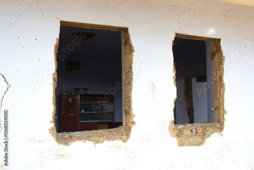Abandoned Building with Damaged Walls and Debris

