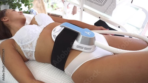 Body contouring and sculpting. Hardware cosmetology. Ultrasound cavitation body contouring treatment, anti-cellulite and anti-fat therapy in beauty salon. Modern beauty treatments concept.