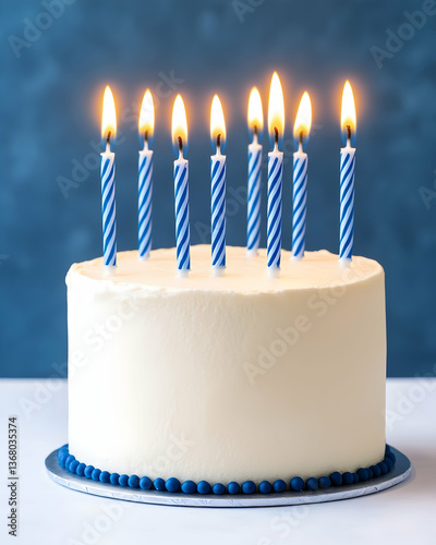 Eight blue-striped candles adorn a white frosted cake