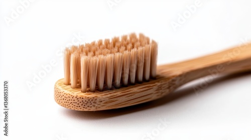 This image showcases an eco-friendly bamboo toothbrush with soft bristles, highlighting its sustainable design and natural materials in clean, minimalistic style.