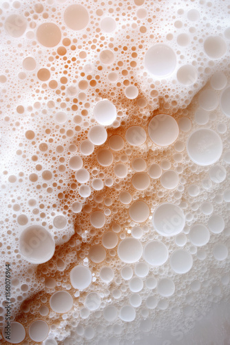 Bubbles create an intricate pattern in a creamy liquid at a close range photo