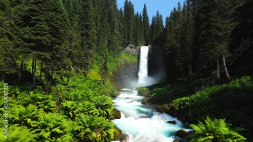 Water Tunnel: Spectacular Waterfall in a Wild Valley with Lush Vegetation and Dense Forest
