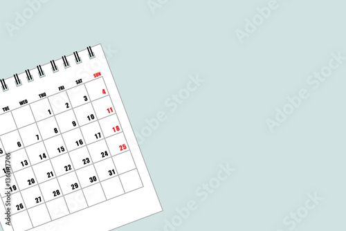 Calendar with empty copy space to list the month and year on a light blue background, flat view or top view with the calendar on the left and text space on the right.