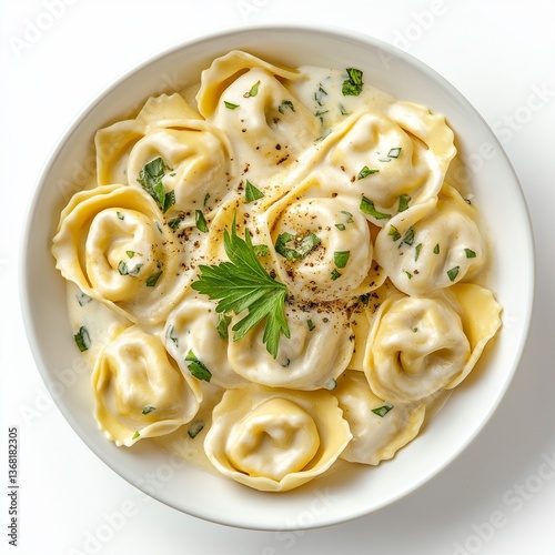 Cheese tortellini with creamy sauce and herbs in bowl