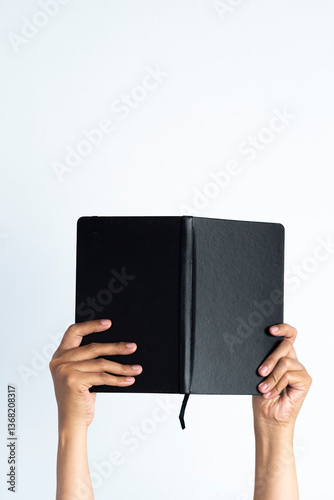 The hands of people hold books. woman's hand holding notebook on white isolated background.