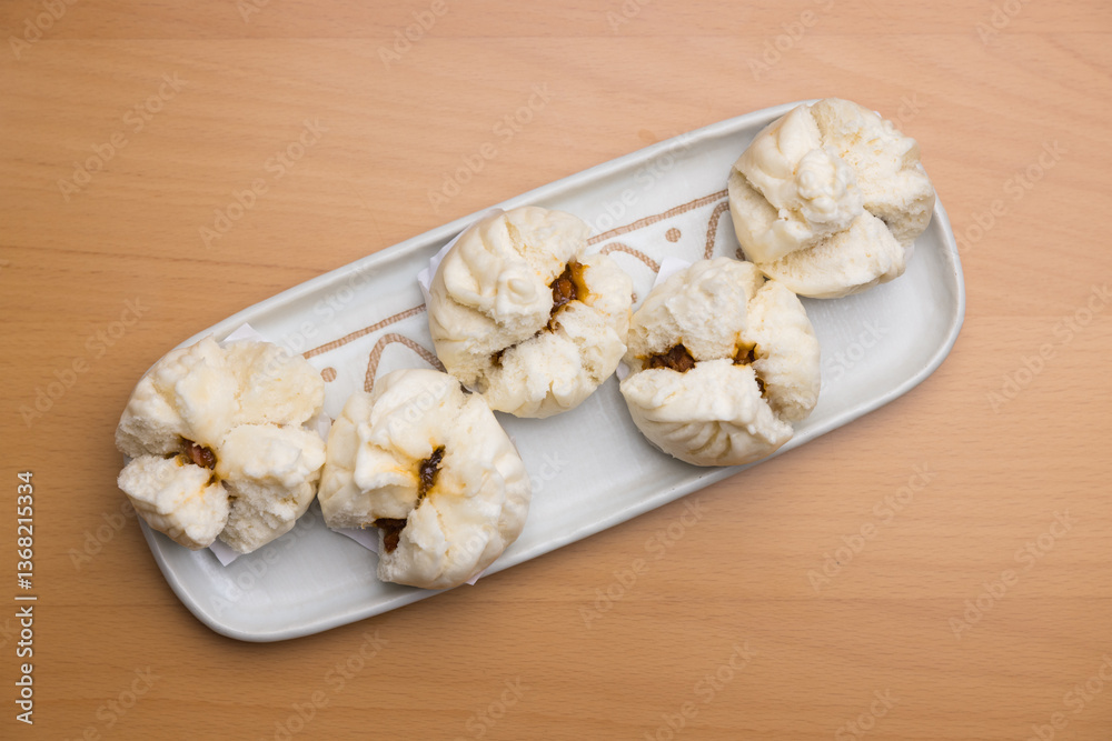 Freshly steamed barbecue pork buns served