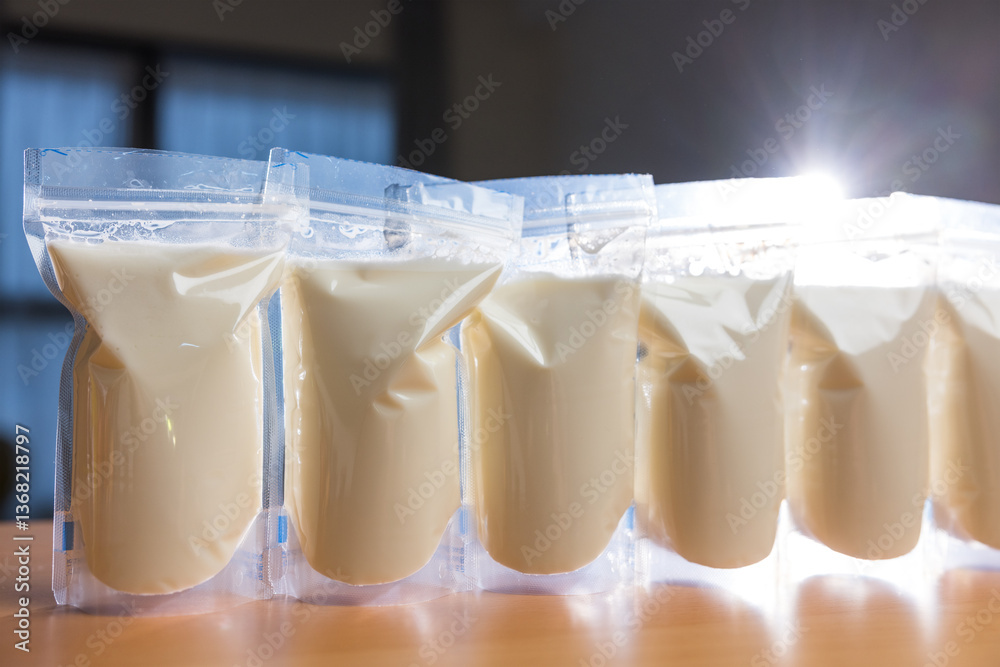 Frozen breast milk bags on wooden table