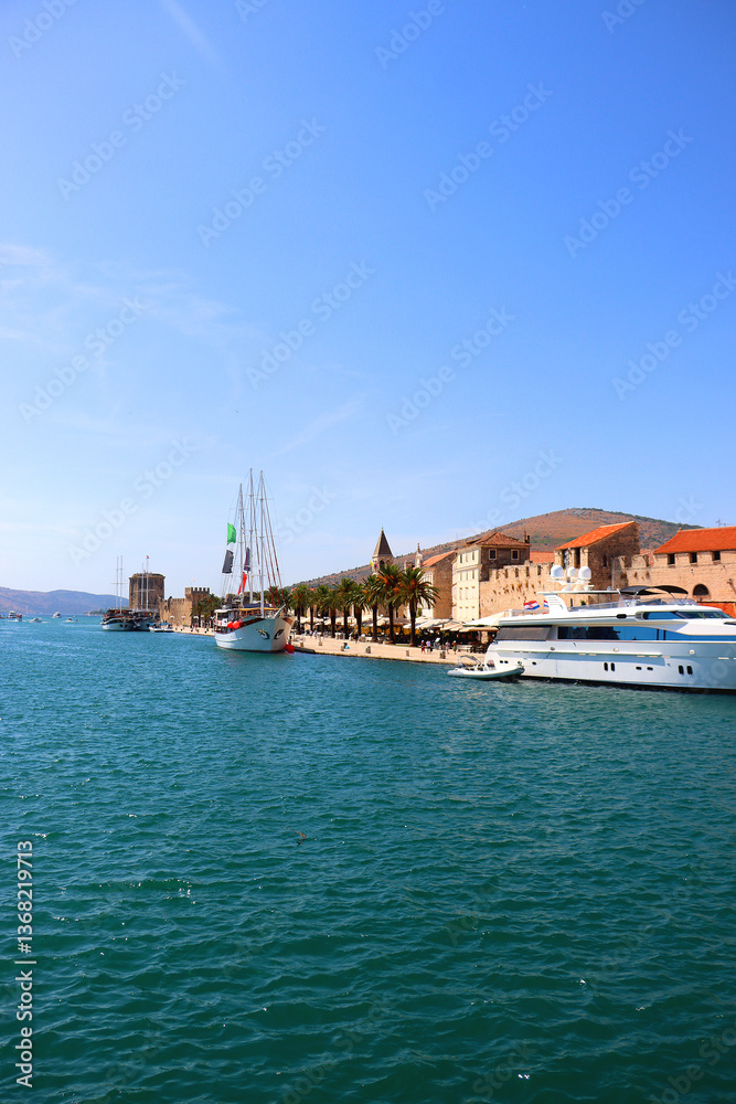 Beautiful old buildings, boats and yachts on the promenade in Trogir, Croatia. Sunny summer day in Trogir.