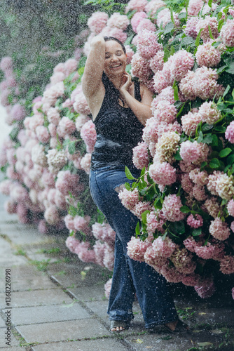Beautiful woman in flowers in the rain. Fashion for plus size.