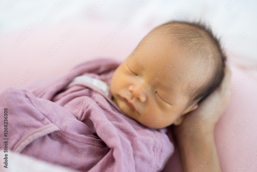 Tiny baby sleeping with hand support