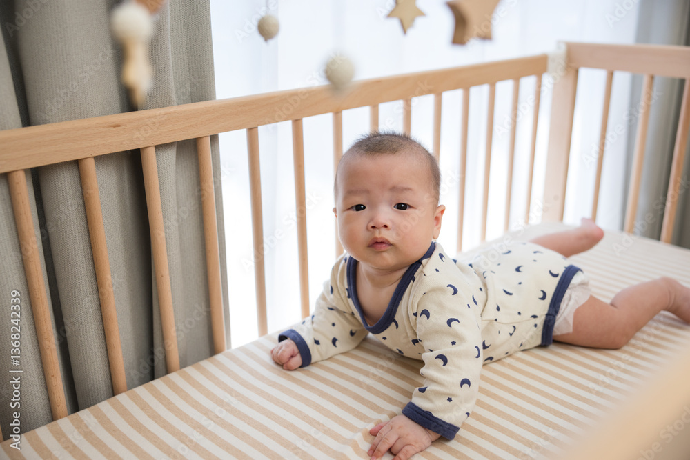 Adorable baby moving inside wooden crib slowly