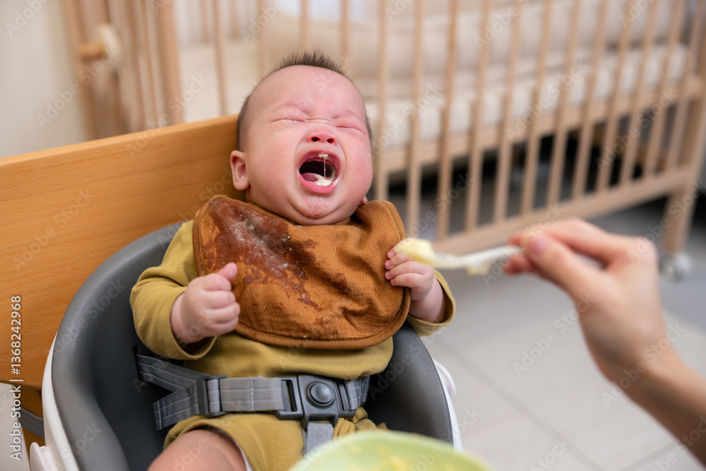 Hungry baby crying while waiting for food