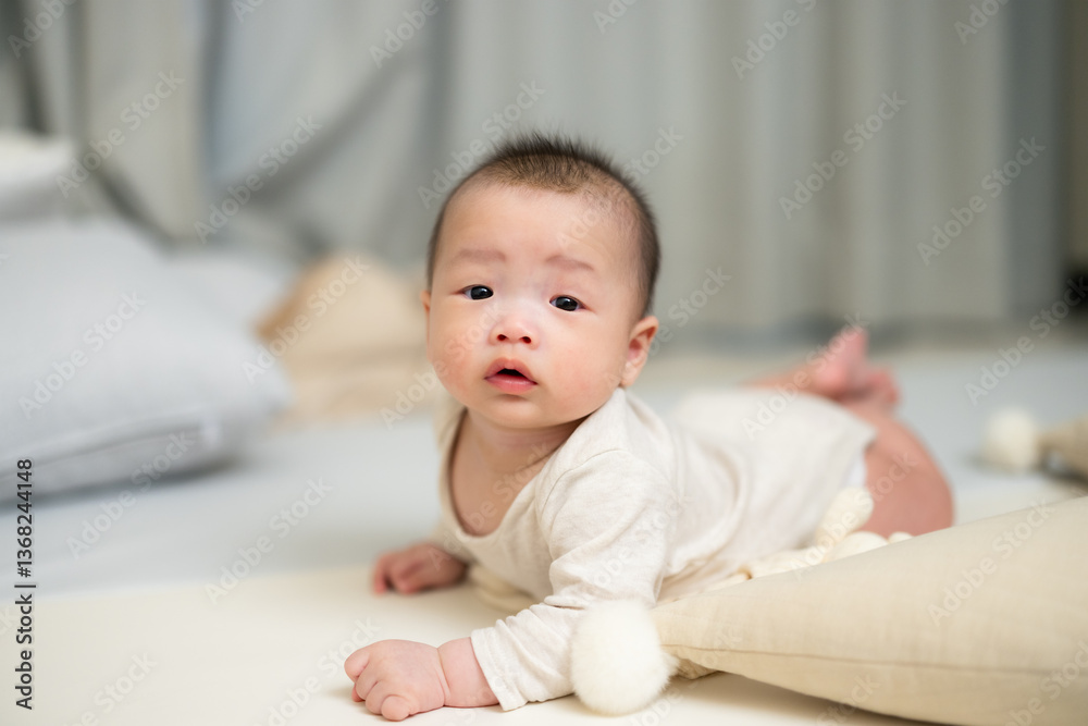Adorable baby learning to lift head up